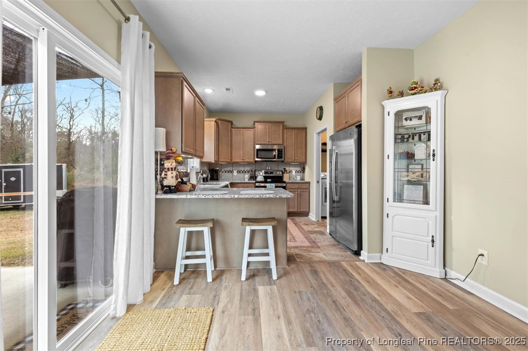 5512 Tolarsville Road St. Pauls, NC 28384 - Photo 9 of 30 a kitchen with white cabinets and stainless steel appliances