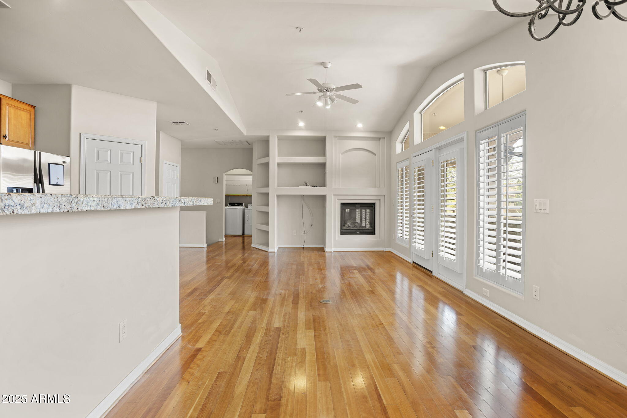 a view of a kitchen with wooden floor and windows