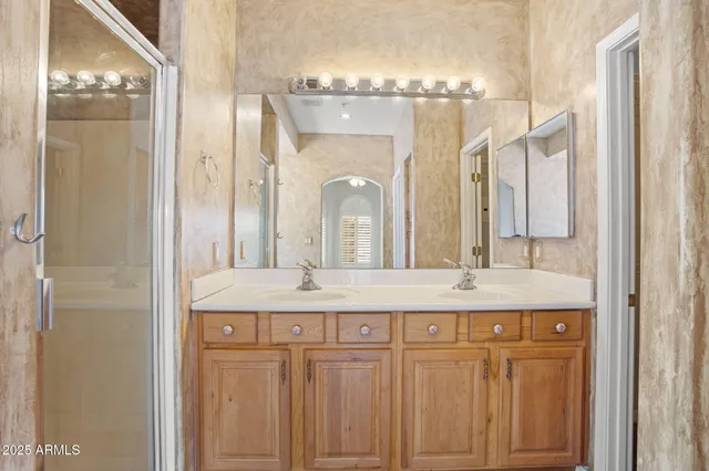 a bathroom with a tub a sink and a large mirror