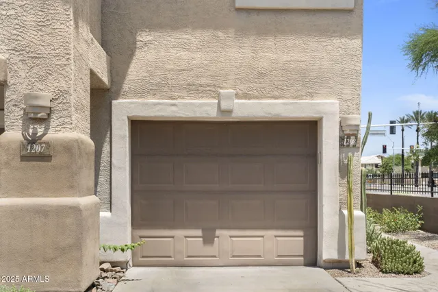 a view of empty room with wooden floor and a window