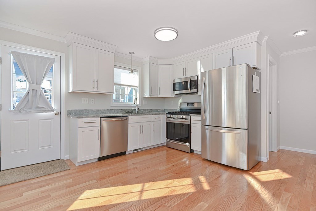 38 Riley Road, Unit 38 Tyngsboro, MA 01879 - Photo 3 of 25 a kitchen with a white cabinets and white stainless steel appliances