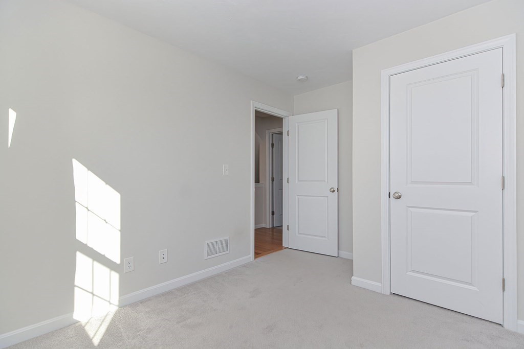 38 Riley Road, Unit 38 Tyngsboro, MA 01879 - Photo 10 of 25 a view of an empty room and a window