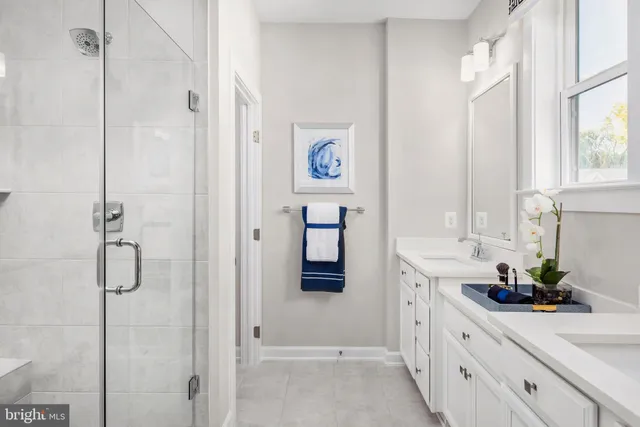 a bathroom with a shower sink and a mirror