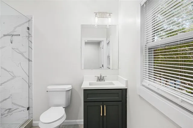 a bathroom with a sink a toilet and shower curtain