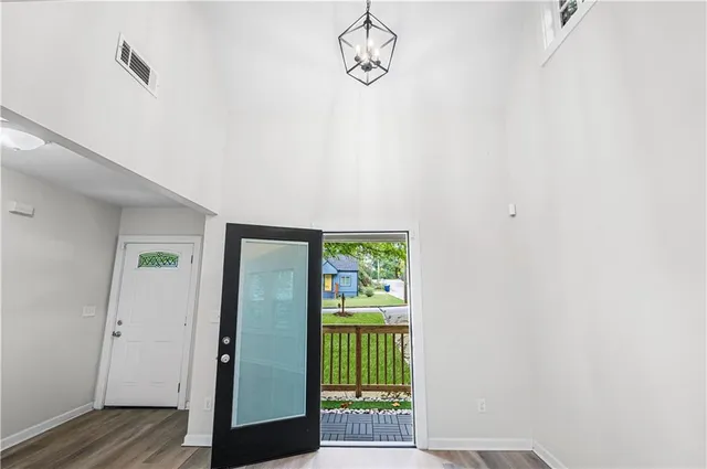 a view of a room with wooden floor and windows