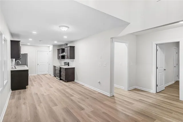 a kitchen with stainless steel appliances a refrigerator sink and microwave