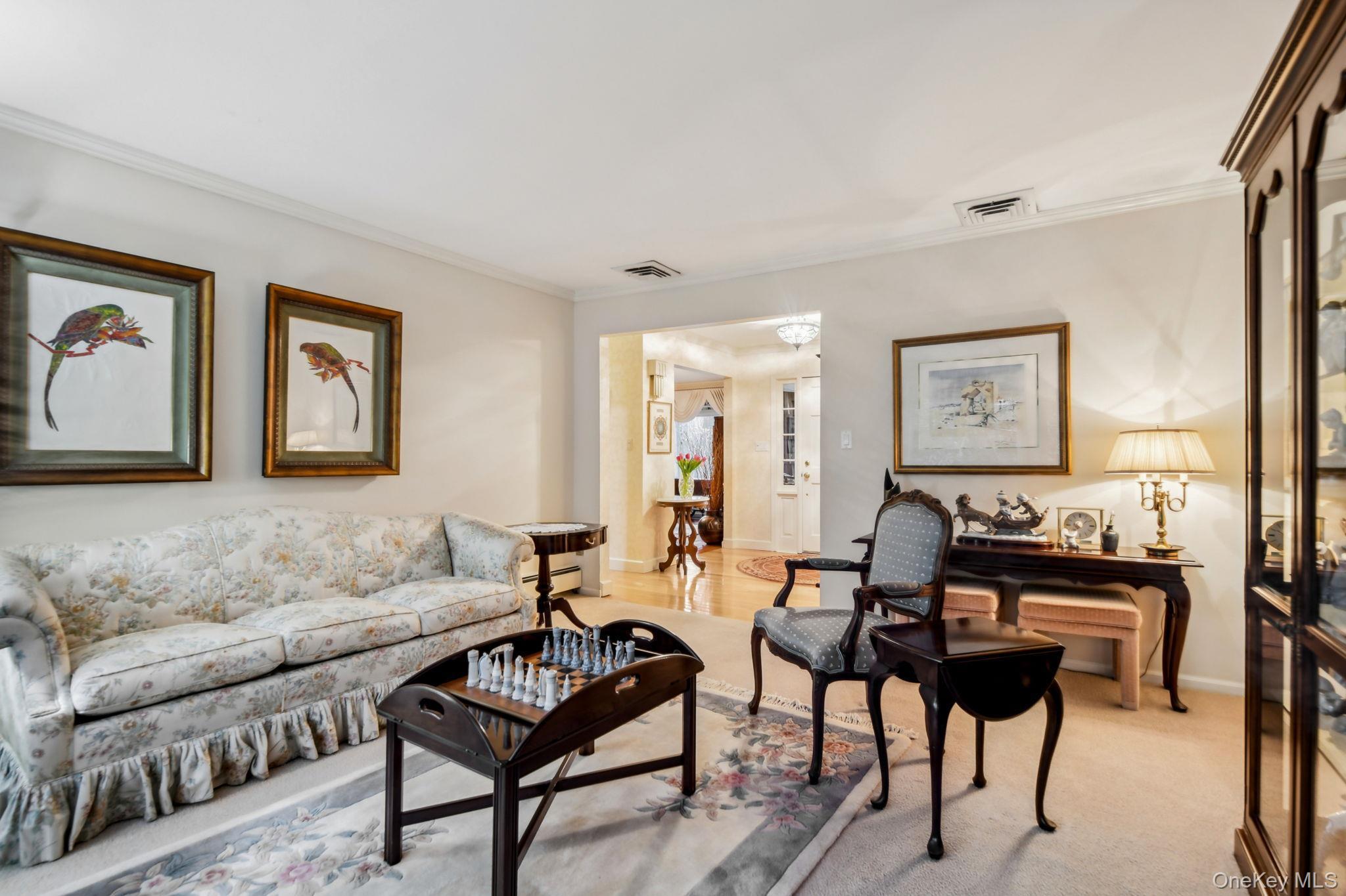 7 Short Path St. James, NY 11780 - Photo 9 of 17 Living area featuring crown molding and carpet floors