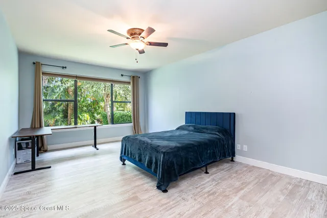 a living room with a bed furniture and a large window
