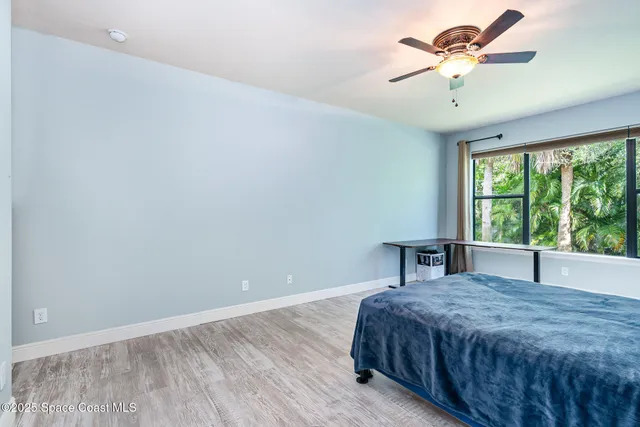 a spacious bedroom with a bed and a chandelier