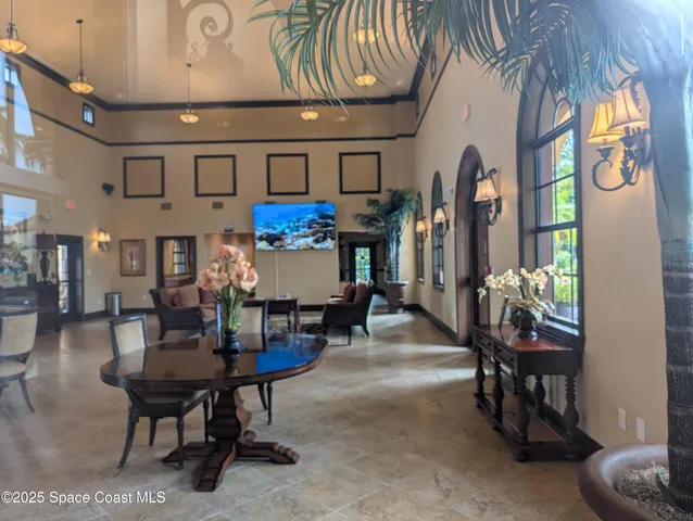 a living room with furniture and a dining table