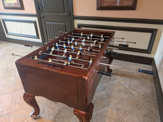 a living room with furniture a piano and a potted plant