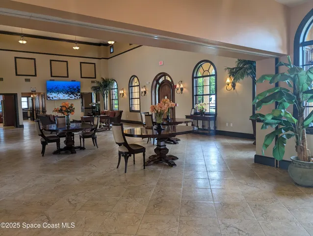 a room with pool table and windows