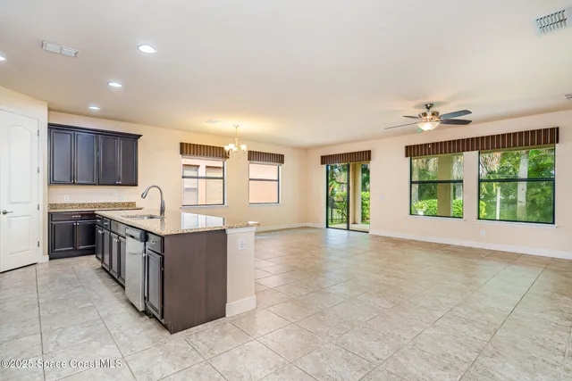 a large kitchen with stainless steel appliances granite countertop a stove and a sink