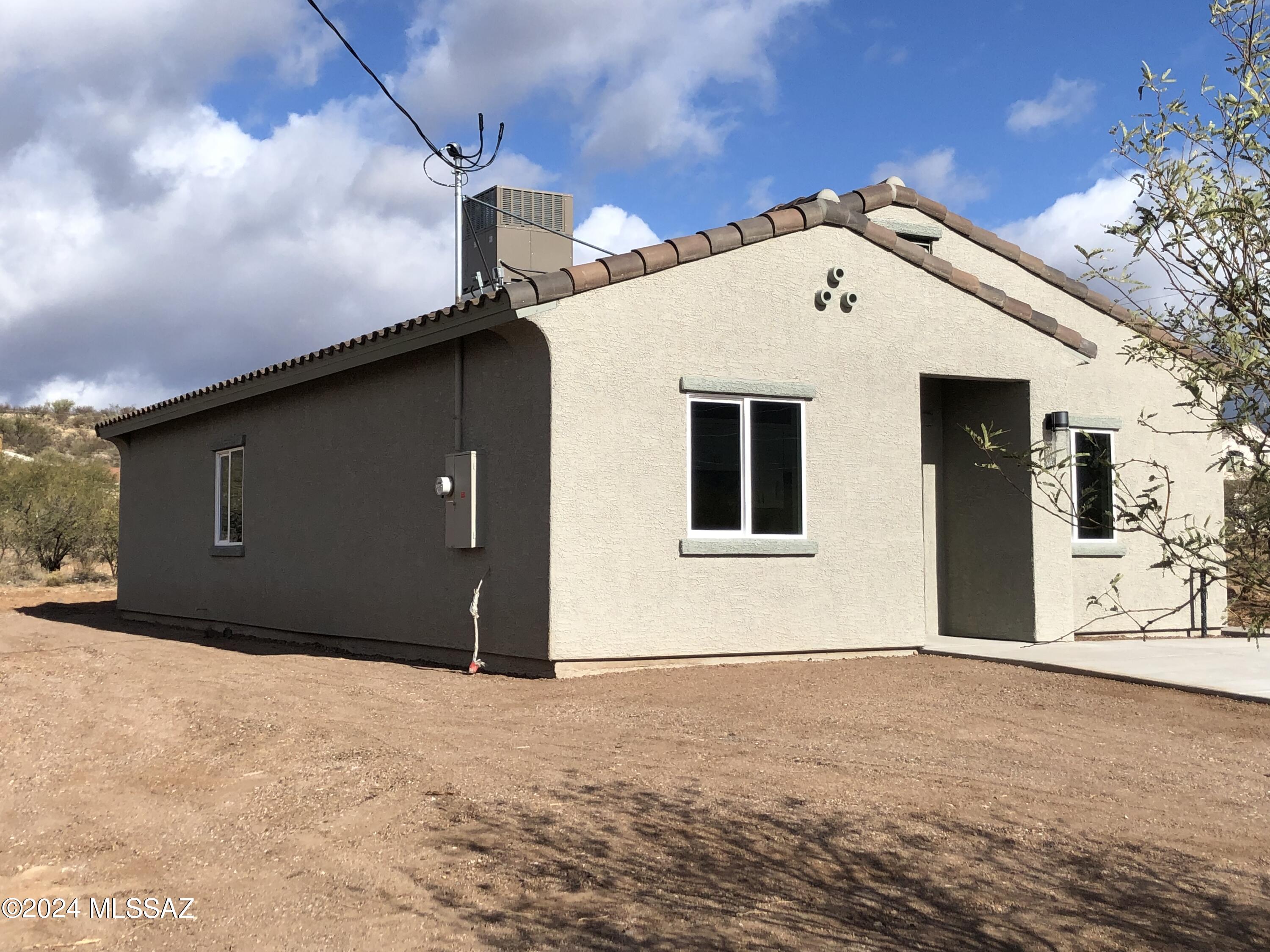 154 Calle Victoria Rio Rico, AZ 85648 - Photo 2 of 27 a front view of a house with a outdoor space