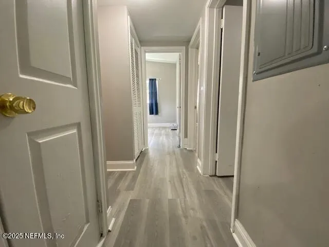 a view of a hallway with wooden floor