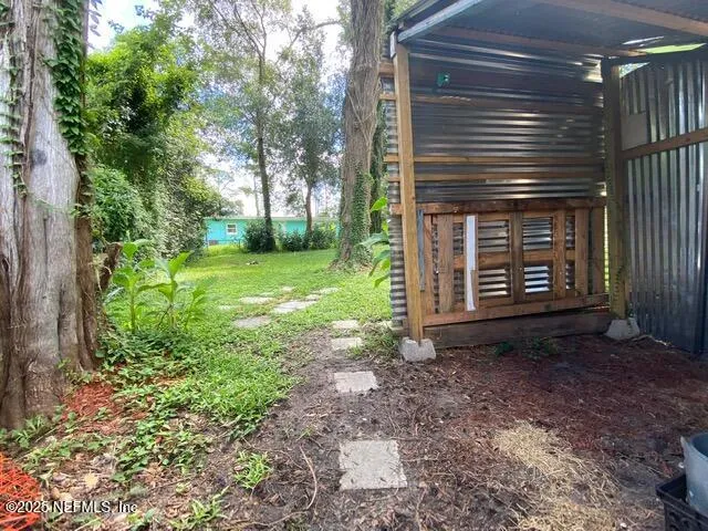 a view of a backyard with large trees