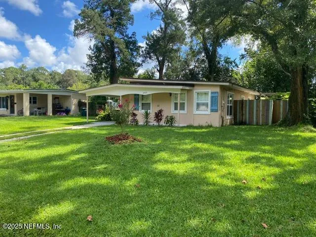 a front view of house with yard and green space