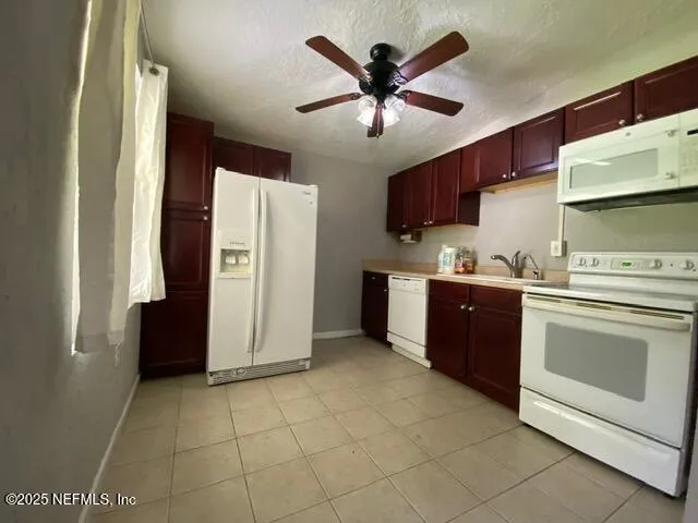 a kitchen with stainless steel appliances granite countertop a refrigerator and a stove
