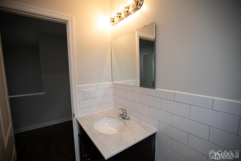 4208 Hana Road Edison, NJ 08817 - Photo 7 of 34 a bathroom with a sink and a mirror