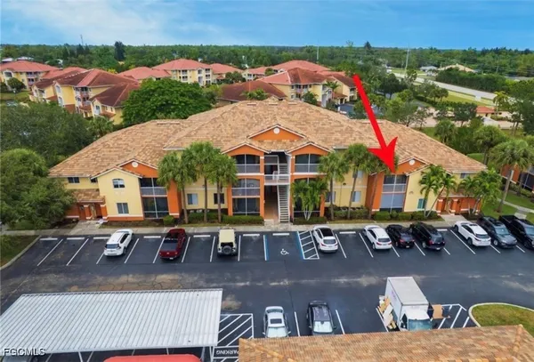 an aerial view of a house with balcony and patio