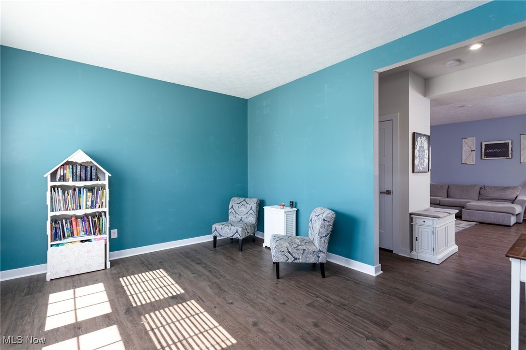 528 Oliver Way Rittman, OH 44270 - Photo 9 of 32 Sitting room with baseboards and dark wood-style LVP flooring