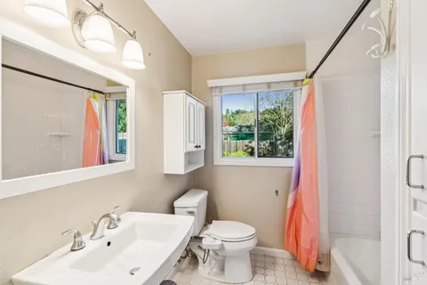 a bathroom with a sink toilet and a mirror