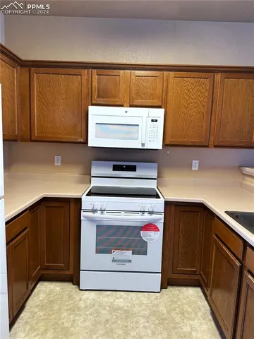 a kitchen with a stove and cabinets