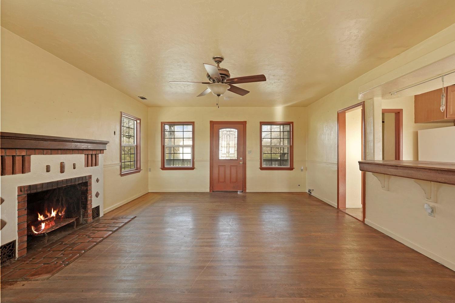 10710 North Shelton Road Linden, CA 95236 - Photo 38 of 75 a view of an empty room with a fireplace and a window