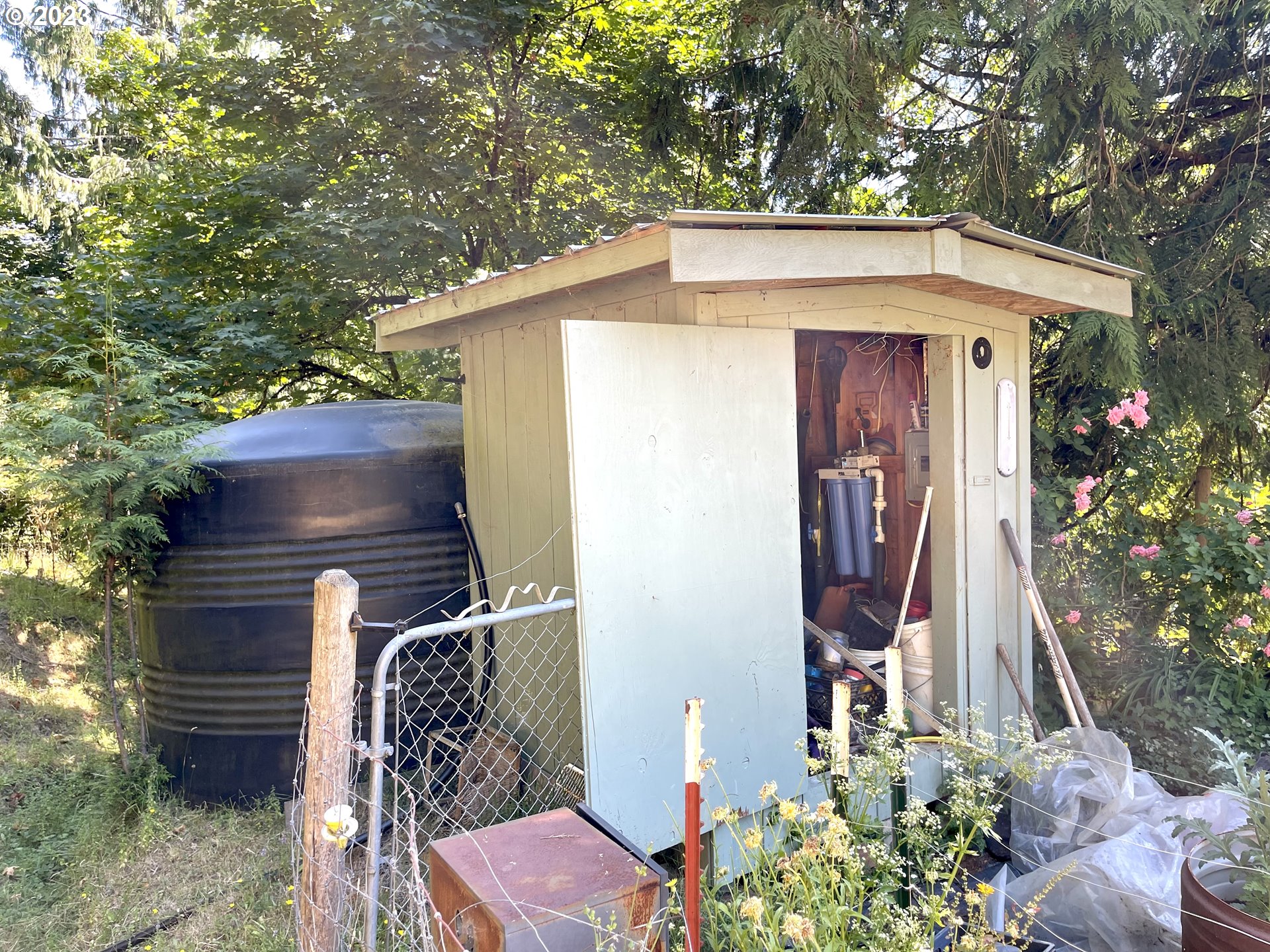 49008 Eckley Mountain Road Broadbent, OR 97414 - Photo 44 of 48 a view of a wooden house with a tree and plants