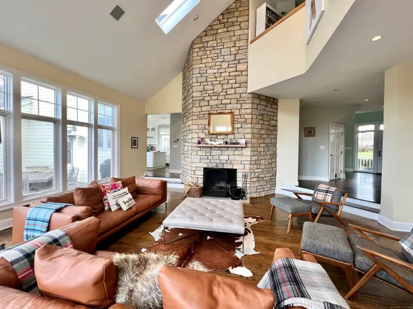 a living room with furniture fireplace and a large window
