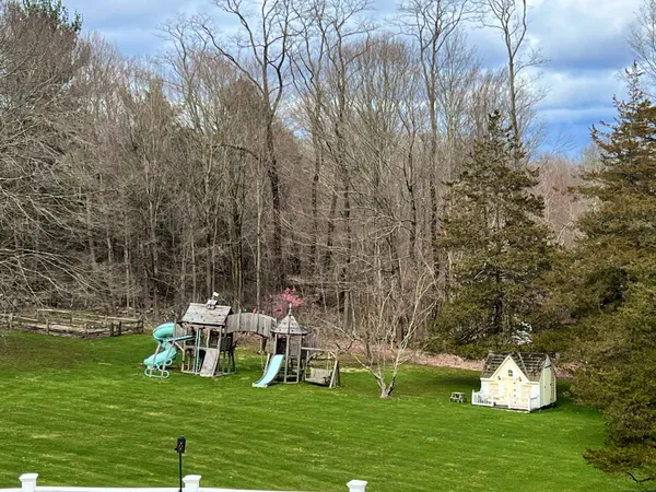 a white house with a yard and sitting area