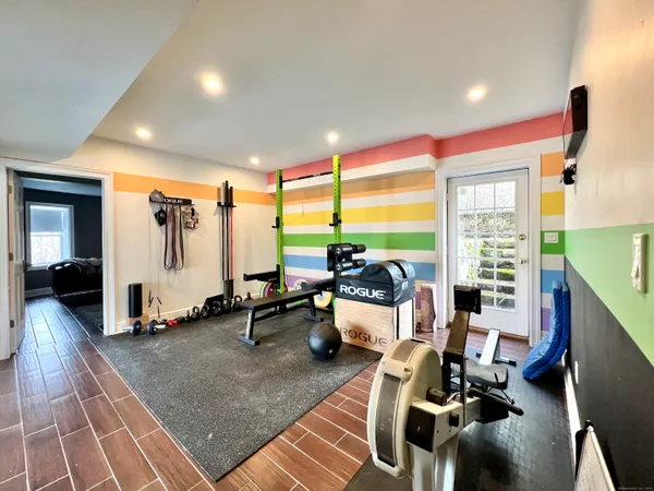 a living room with furniture gym equipment and a large window