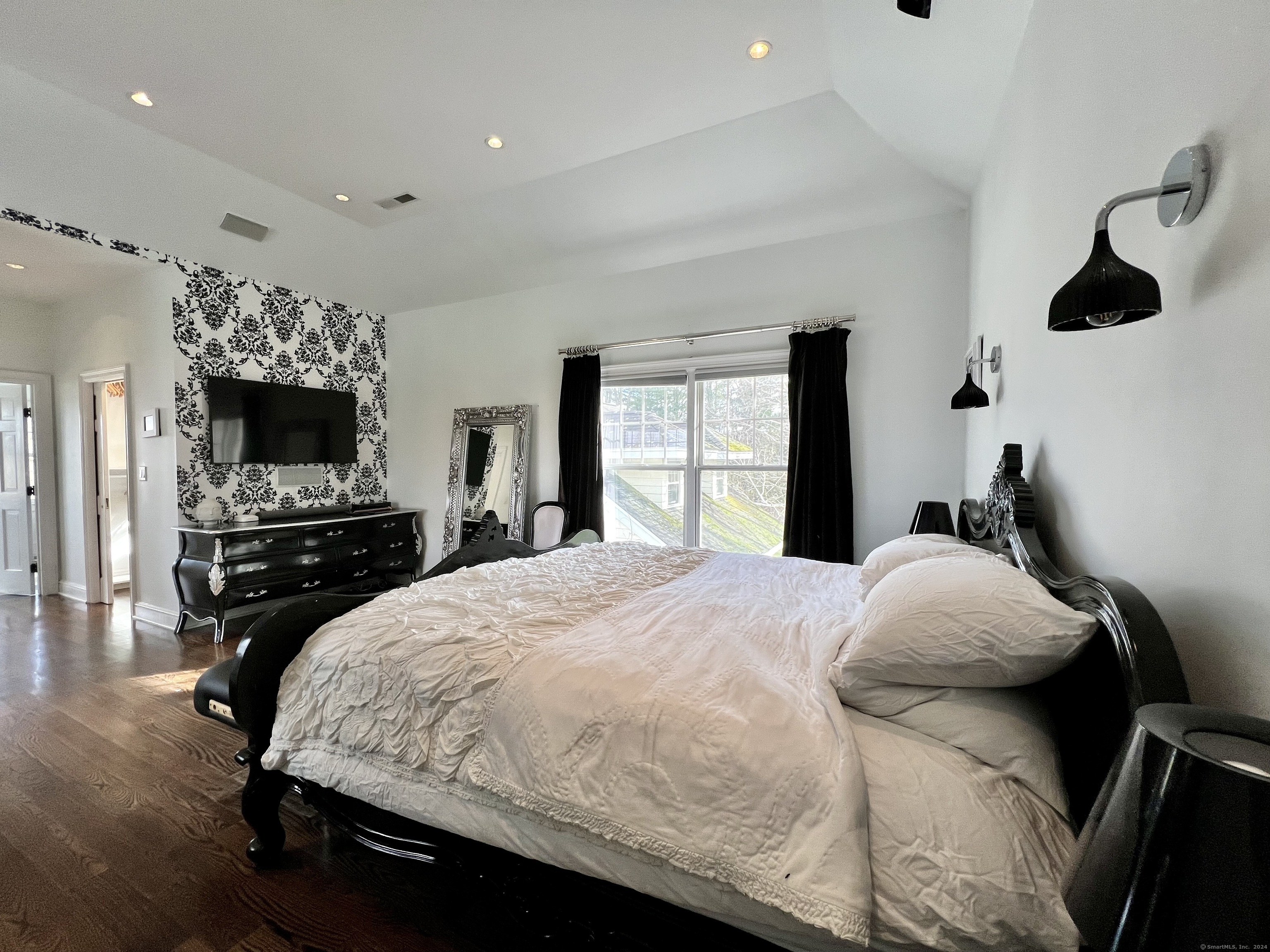 172 Umpawaug Road Redding, CT 06896 - Photo 19 of 38 a bedroom with a bed and a flat screen tv