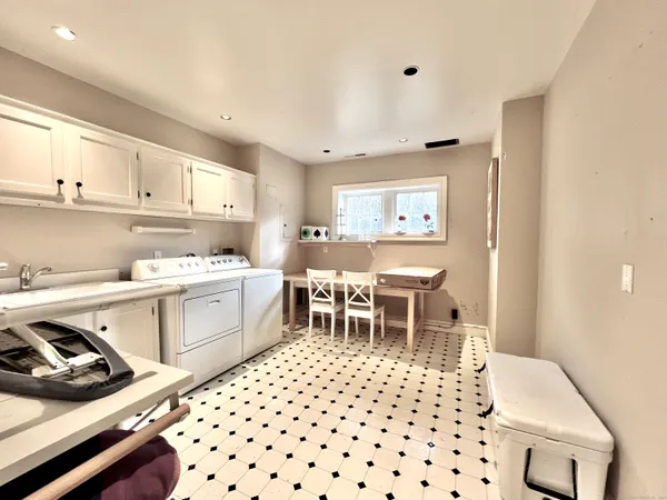a kitchen with a sink and chairs