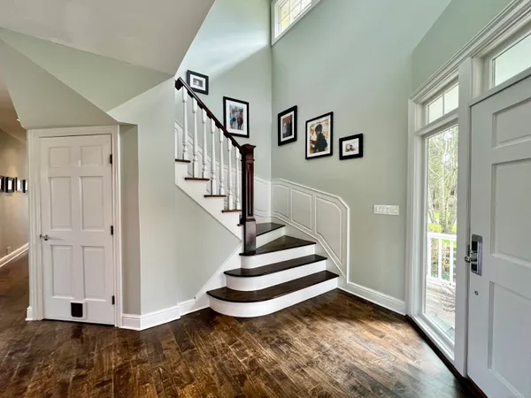 a view of entryway and hall with wooden floor