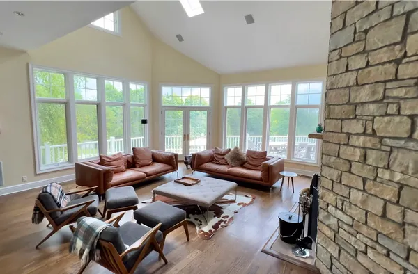 a living room with furniture and a floor to ceiling window
