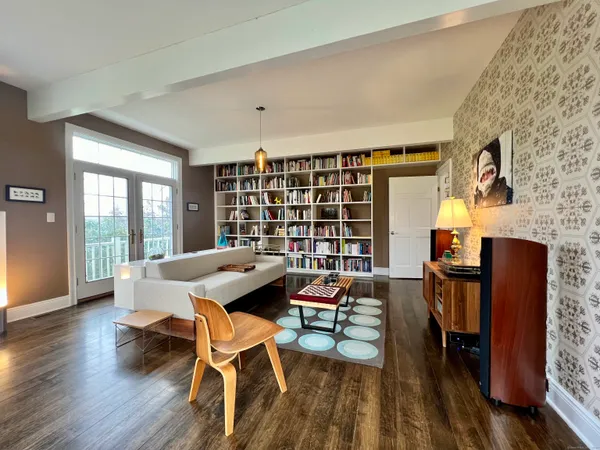 a living room with furniture and a wooden floor