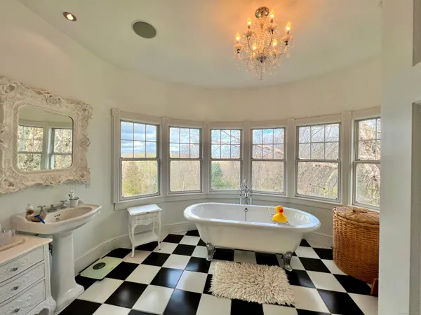 a spacious bathroom with a sink a bath tub and a window