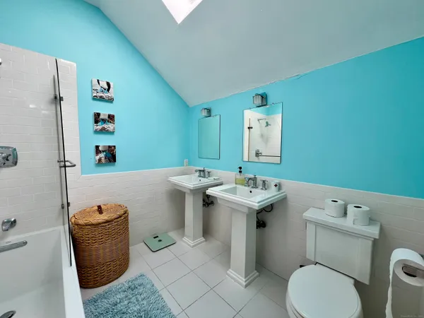 a bathroom with a sink toilet and mirror