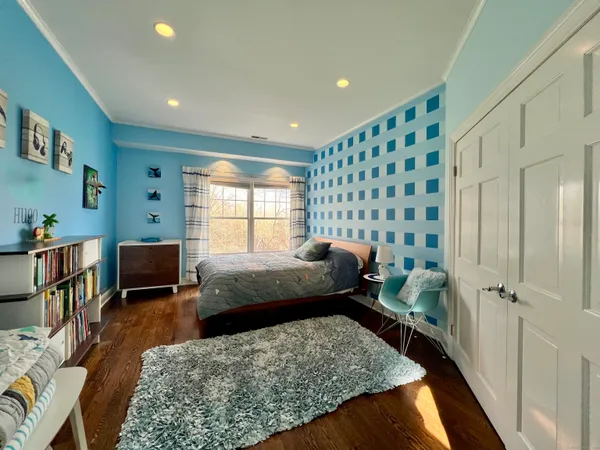 a bedroom with furniture and a window