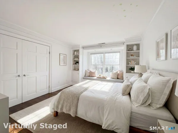 a spacious bedroom with a bed and a large window