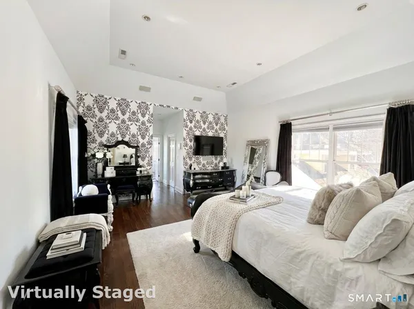 a bedroom with a bed and a television