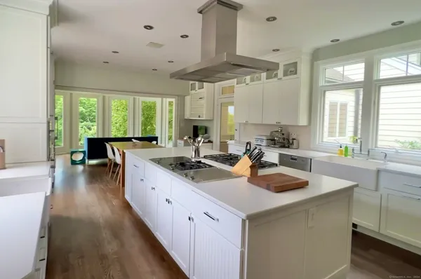 a kitchen with a sink stove and cabinets