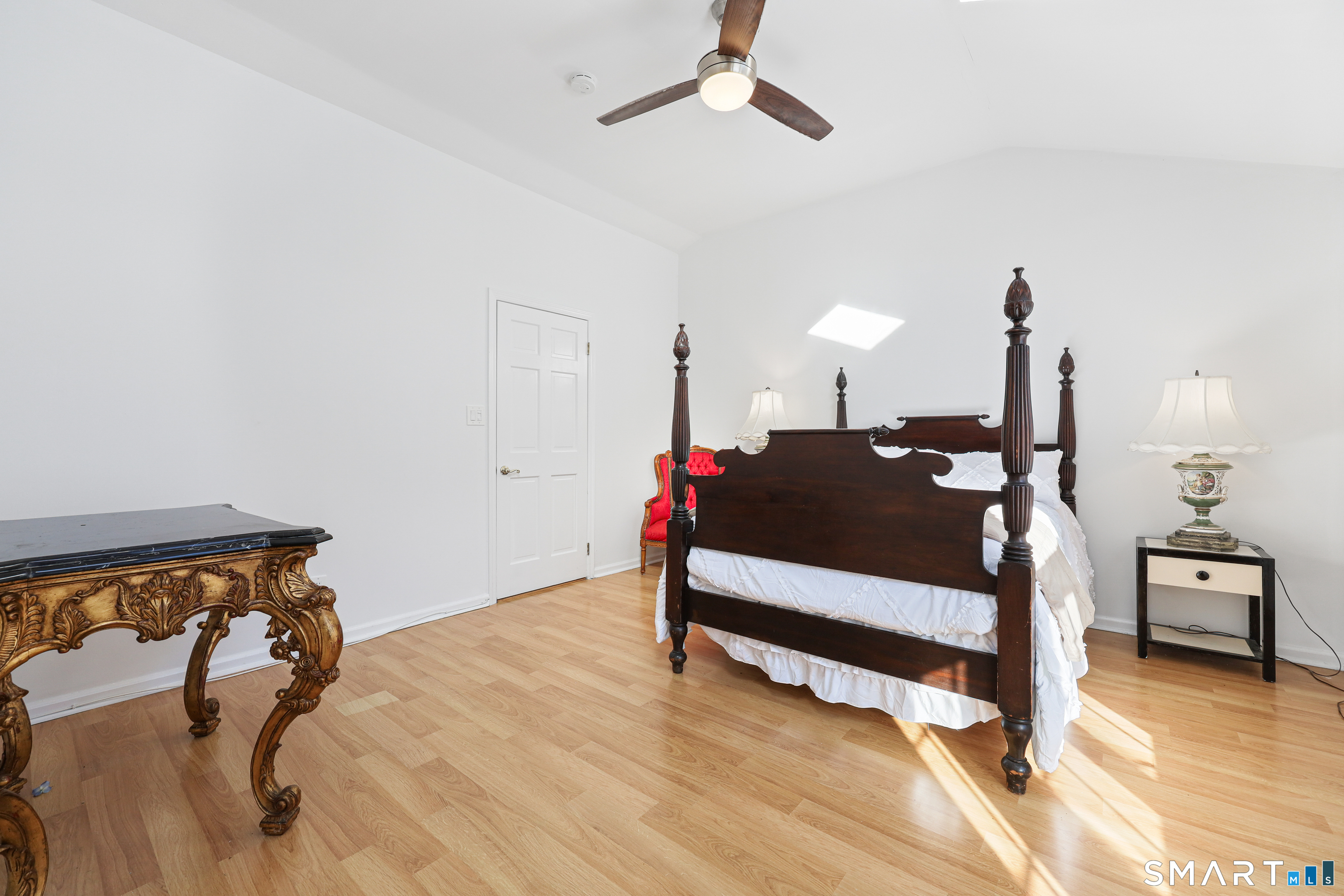 1215 Westover Road Stamford, CT 06902 - Photo 13 of 27 a bedroom with a bed and a table