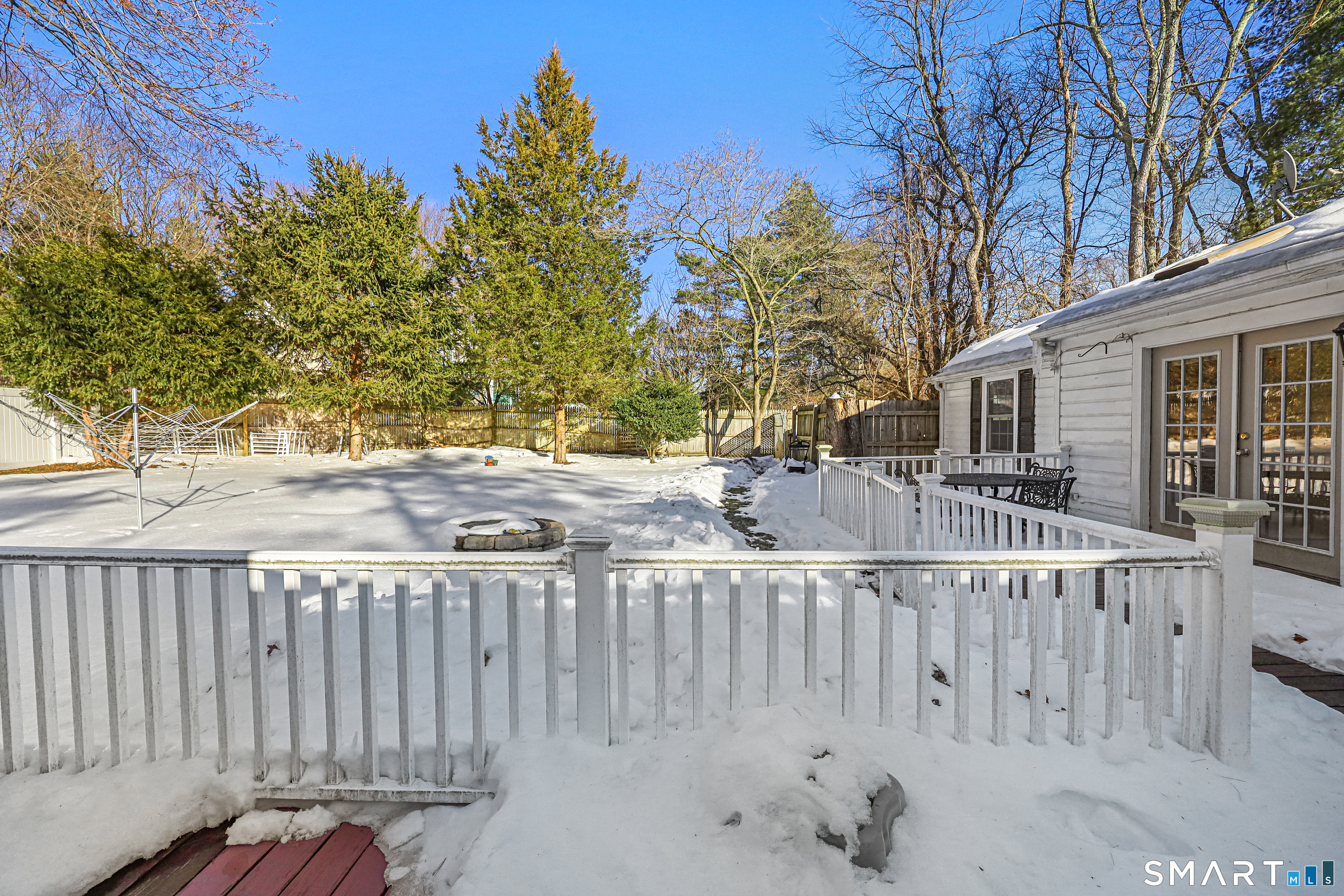 1215 Westover Road Stamford, CT 06902 - Photo 24 of 27 a view of a house with a small yard and wooden fence