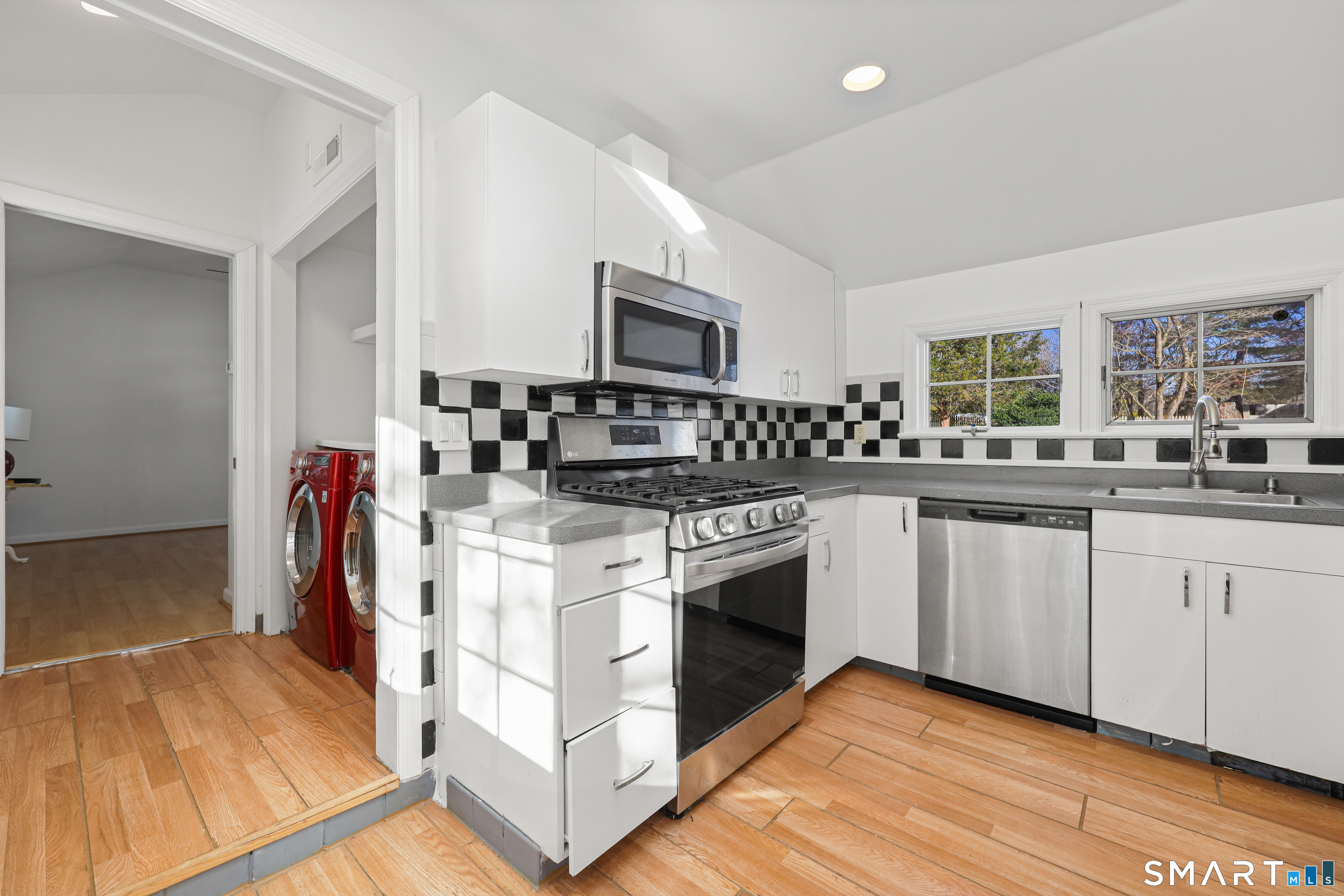 1215 Westover Road Stamford, CT 06902 - Photo 7 of 27 a kitchen with stainless steel appliances granite countertop a stove and a sink