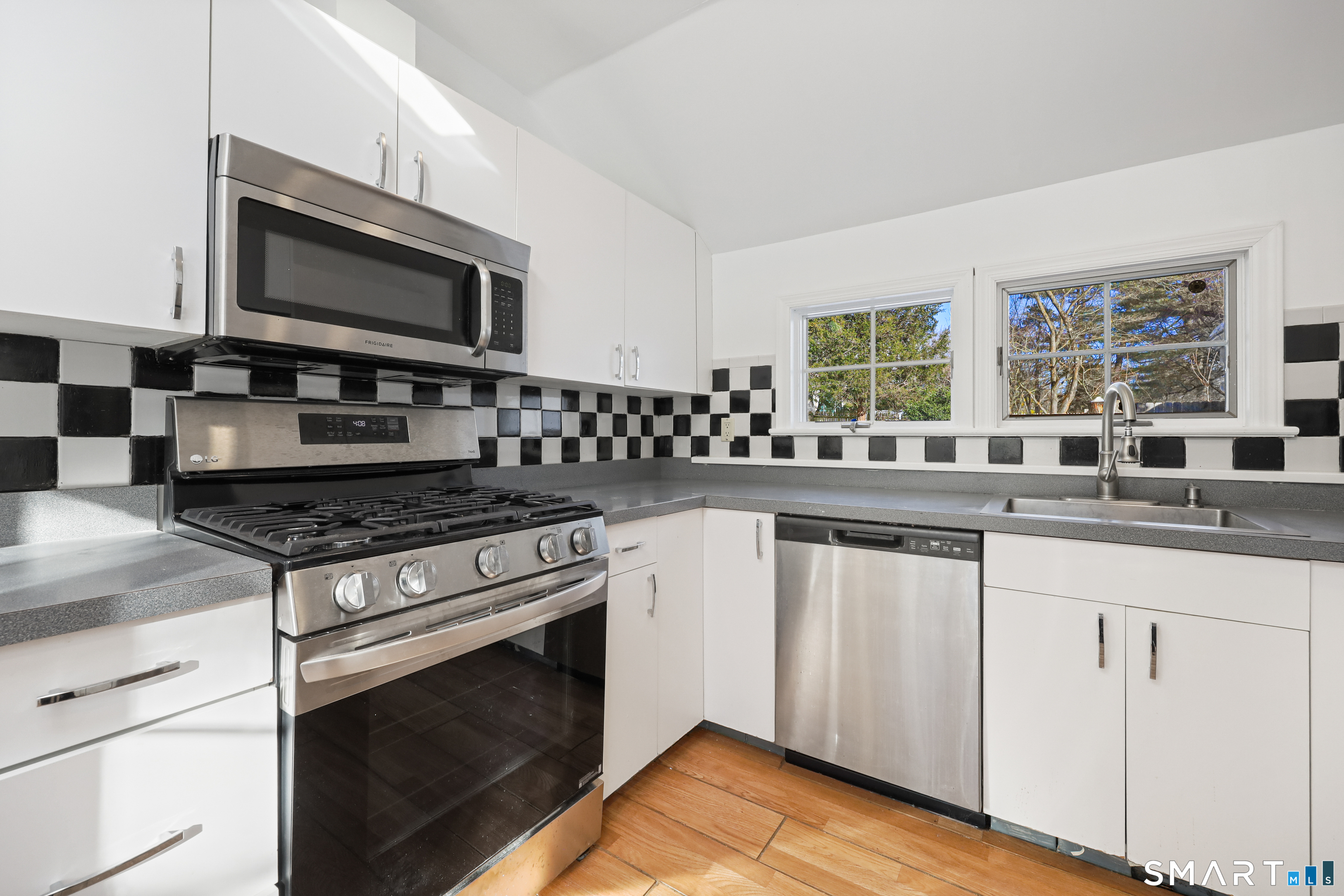 1215 Westover Road Stamford, CT 06902 - Photo 8 of 27 a kitchen with granite countertop a stove and a sink