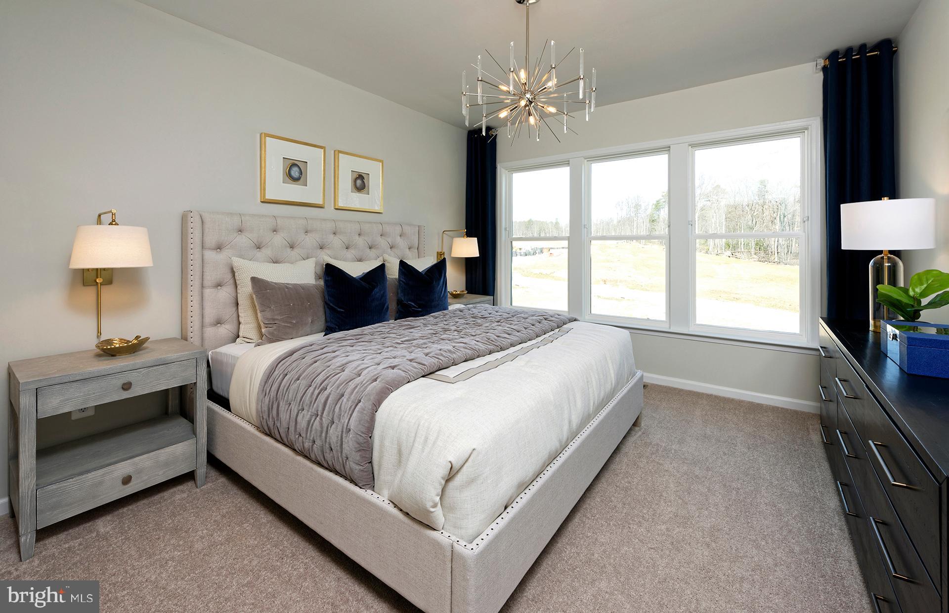 238 Mainstream Drive Laurel, MD 20724 - Photo 7 of 30 a spacious bedroom with a bed and a chandelier