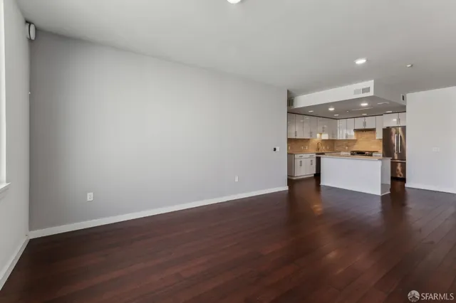 a view of a kitchen with a sink and a refrigerator