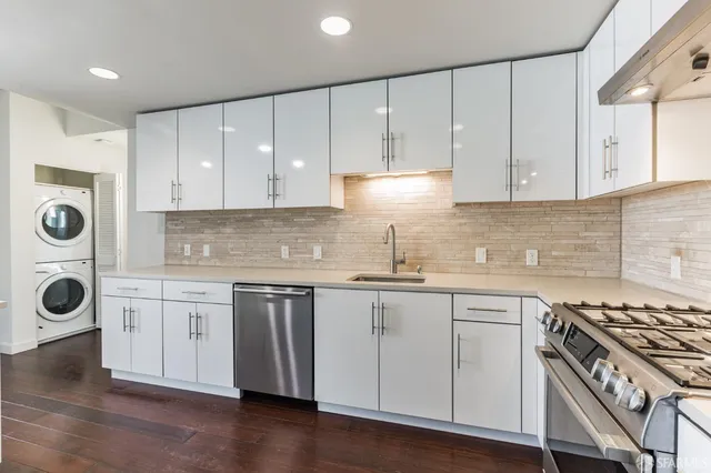 a kitchen with granite countertop white cabinets and white appliances
